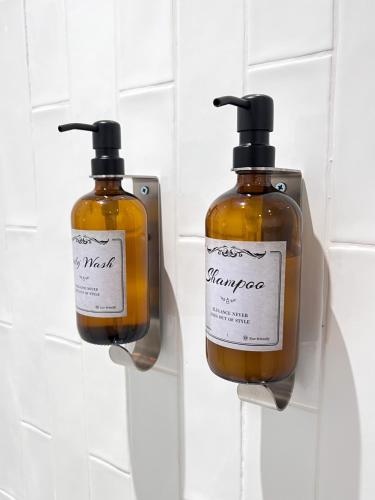 two bottles of soap are hanging on a wall at Aplanty Studio in the Orchard in Walsoken