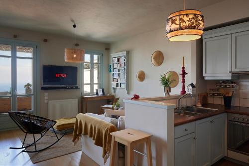 Cycladic Villa ERoza في لوليدا: مطبخ مع حوض وغرفة معيشة