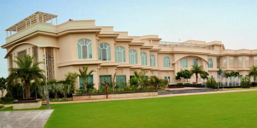 a large house with a lawn in front of it at The Umrao in New Delhi