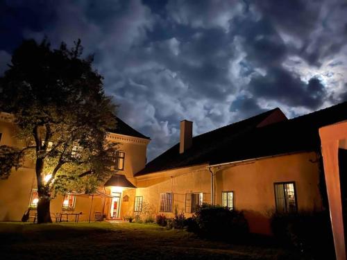 a building with a tree in front of it at night at Landhaus im Waldviertel in Zwettl Stadt