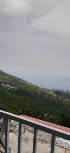 a view of a hill with the ocean in the background at Haputale Super View in Haputale