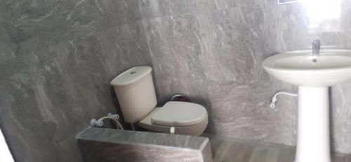 a bathroom with a toilet and a sink at Haputale Super View in Haputale