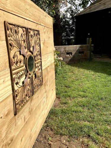 a wooden fence with a metal design on it at Crossing Retreat - POOL table, PROJECTOR, BARN in Tunstead