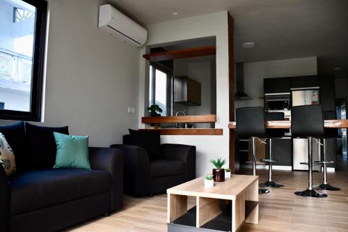 a living room with a couch and a table at Bel appartement proche de la plage Trou Aux Biches in Trou aux Biches