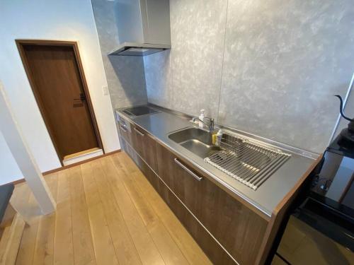 a kitchen with a sink and a counter top at FTH Moon Light 3min to Sta. in Shimo-yoshida