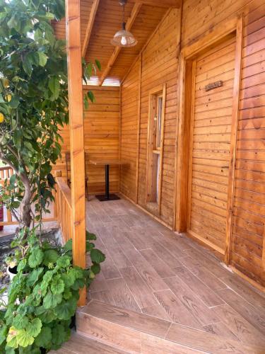 a porch of a wooden cabin with a wooden floor at Cilek Butik Hotel in Cesme