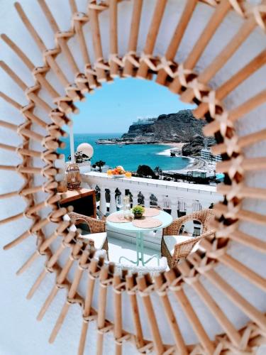a view of the ocean through a wooden fence at Gran Ocean View in Playa del Cura