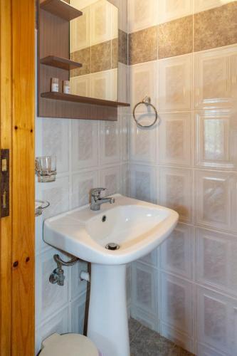 a bathroom with a white sink and a mirror at Pension Veria Frankfurt in Akti Salonikiou