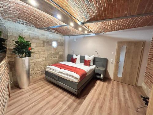 a bedroom with a bed and a brick wall at Chalet Apartment 1 