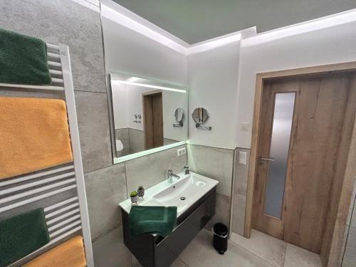 a bathroom with a sink and a mirror at Chalet Apartment 1 