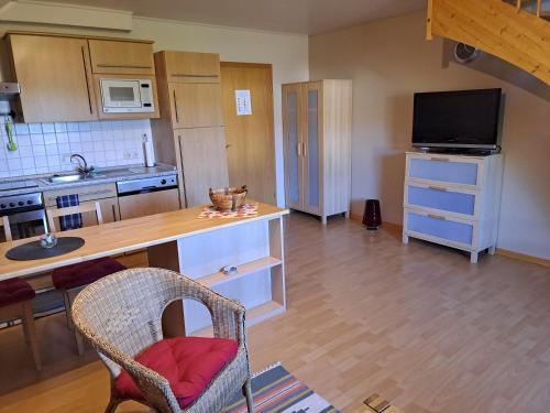 a kitchen with a table and a counter top at Ferienwohnung-Pruemtalblick in Prüm