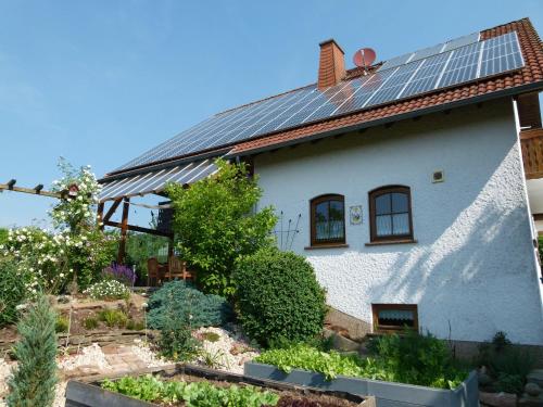 a house with solar panels on the roof at Ferienwohnung-Pruemtalblick in Prüm