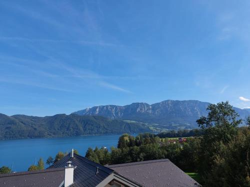 a view of a lake with mountains in the background at Ferienwohnung Claudia mit Terrasse in Nussdorf am Attersee