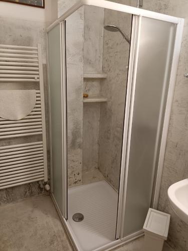 a shower with a glass door in a bathroom at B&B La Casarella in Soiano del Lago