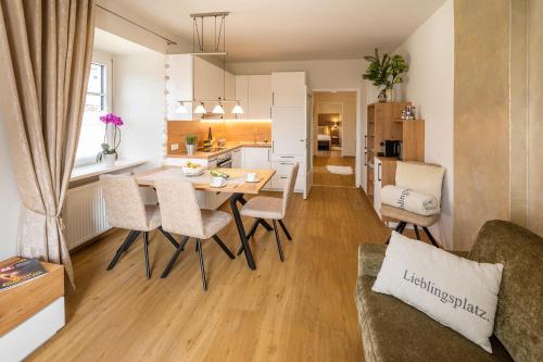 a kitchen and living room with a table and chairs at Appartements am Landschaweg in Weiz