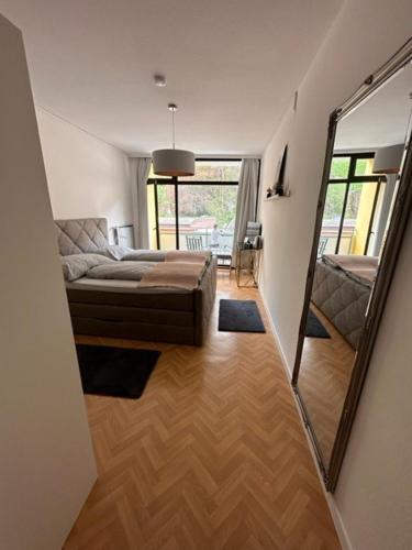 a living room with a couch and a mirror at Pension COLUMBIA inkl. Frühstück im Zentraum in Bad Gleichenberg