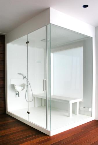 a glass shower stall with a sink in a room at Camping Joncar Mar in Roses