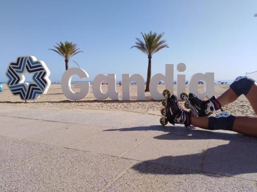 a person laying on a skateboard in front of a sign at Hotel Clibomar Jamaica in Gandía