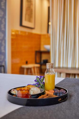 a plate of food on a table with orange juice at THE PINTA Boutique in Armamar