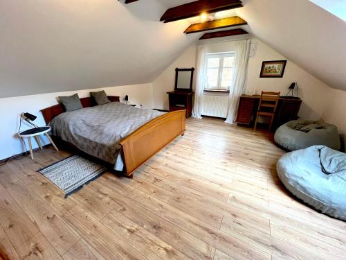 a attic bedroom with a bed and a desk at MATOGÓWKA in Krzeszowice