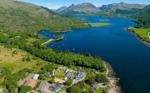 an aerial view of a lake with mountains at Loch Leven Hotel & Distillery in Glencoe