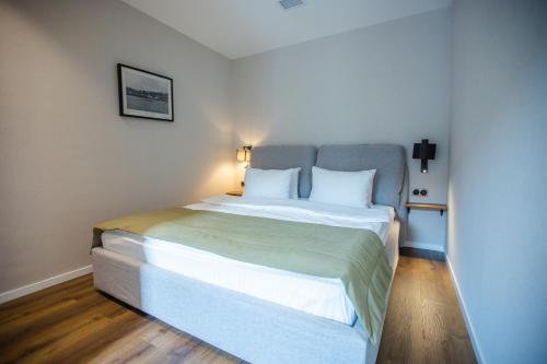 a bedroom with a large bed with white pillows at Golden Horn Apart Hotel in Baku