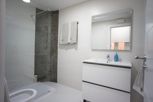a white bathroom with a sink and a toilet at Residencial Art Brut in Castellón de la Plana