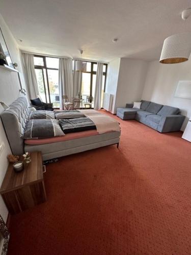 a large living room with a bed and a couch at Pension COLUMBIA inkl. Frühstück im Zentraum in Bad Gleichenberg