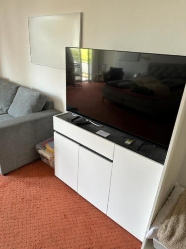 a living room with a large flat screen tv at Pension COLUMBIA inkl. Frühstück im Zentraum in Bad Gleichenberg