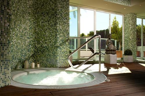 a bathroom with a jacuzzi tub in a building at Ona Marinas de Nerja Spa Resort in Nerja