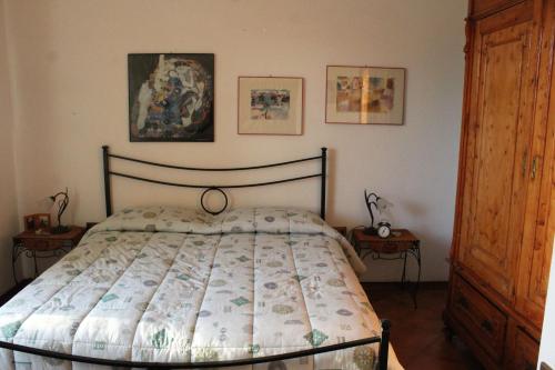 a bedroom with a bed and two end tables at Bencini Family in Montefiridolfi