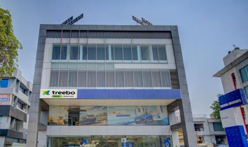 a tall building with a tico sign on it at Treebo Trend Grand Lotus in Surat