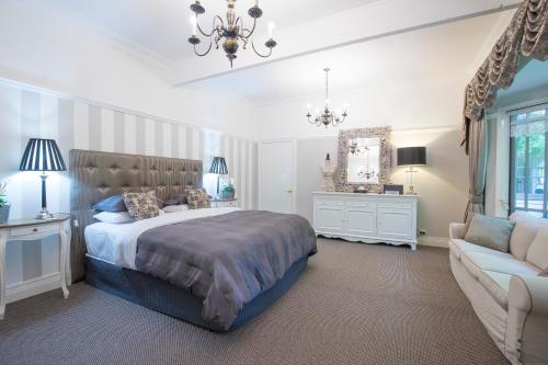 a bedroom with a large bed and a couch at Belle Le Vie in Sassafras