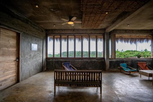 a room with chairs and a table and windows at Izustarri in Burgos