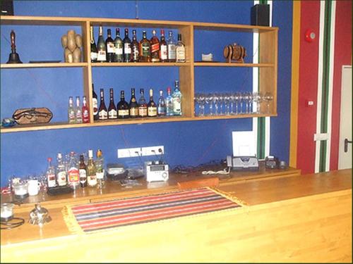 a bar with bottles of alcohol on the wall at Madise Guesthouse in Jõgeva