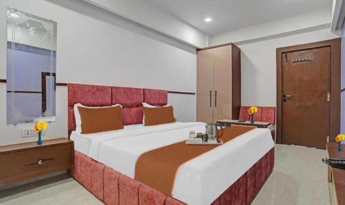 a bedroom with a large bed in a room at FabHotel Elite Residency in Indore