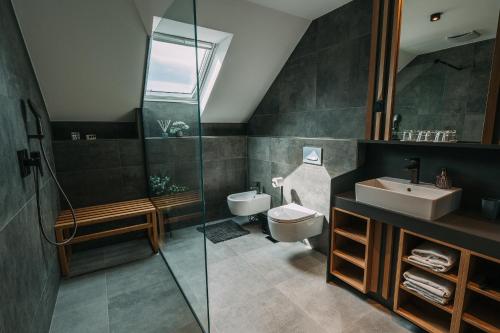 a bathroom with a toilet and a sink and a shower at Guest House Pohorska Kavarna in Maribor