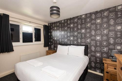 a bedroom with a bed and a black and white wall at Barden Moor in Darlington