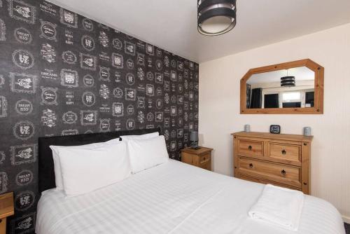 a bedroom with a bed with a black and white wall at Barden Moor in Darlington