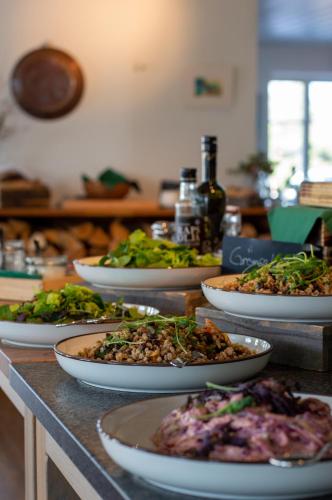 a group of plates of food on a counter at Skeviks Gård in Gustavsberg