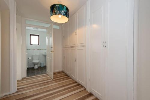 a hallway with a bathroom with a toilet and a light fixture at Bousfield Crescent in Newton Aycliffe