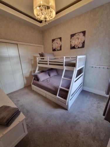 a bedroom with a bunk bed and a chandelier at Lovely home close to MCR centre inc Cinema in Manchester