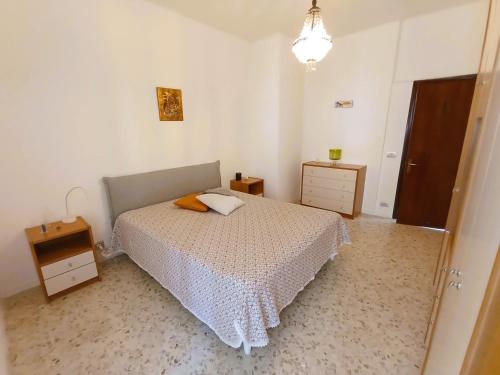 a bedroom with a bed and a dresser and a night stand at Casa Vacanze AlbA in Bari