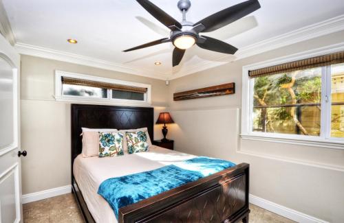a bedroom with a ceiling fan and a bed at Villa Bella Mare at the Retreat in Laguna Beach in Laguna Beach