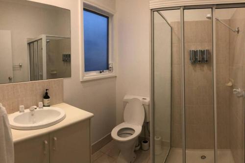 a bathroom with a toilet and a sink and a shower at 4 bedroom family holiday home with large deck in Blairgowrie