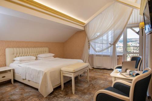 a bedroom with a white bed and a window at Kyivska Russ Resort Medical&Spa in Skhidnitsa