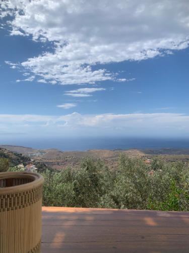 a view of the ocean from the balcony of a house at Cycladic Villa ERoza in Ioulida