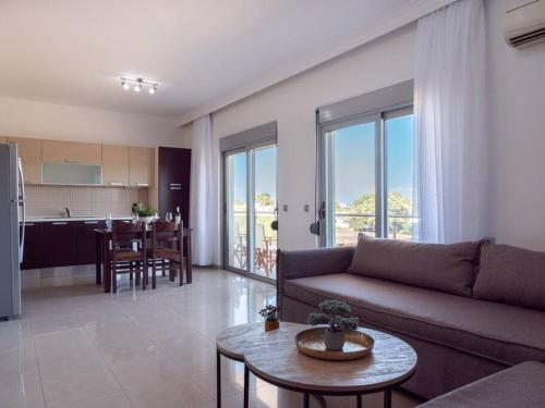 a living room with a couch and a table at Apartment Santa Marina 5 in Asgourou