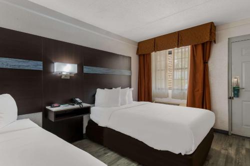 a hotel room with two beds and a window at Quality Inn & Suites Airport in Charlotte