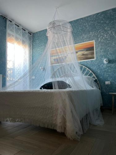 a bedroom with a bed with a net on it at B&B Zio Cici in Minervino di Lecce